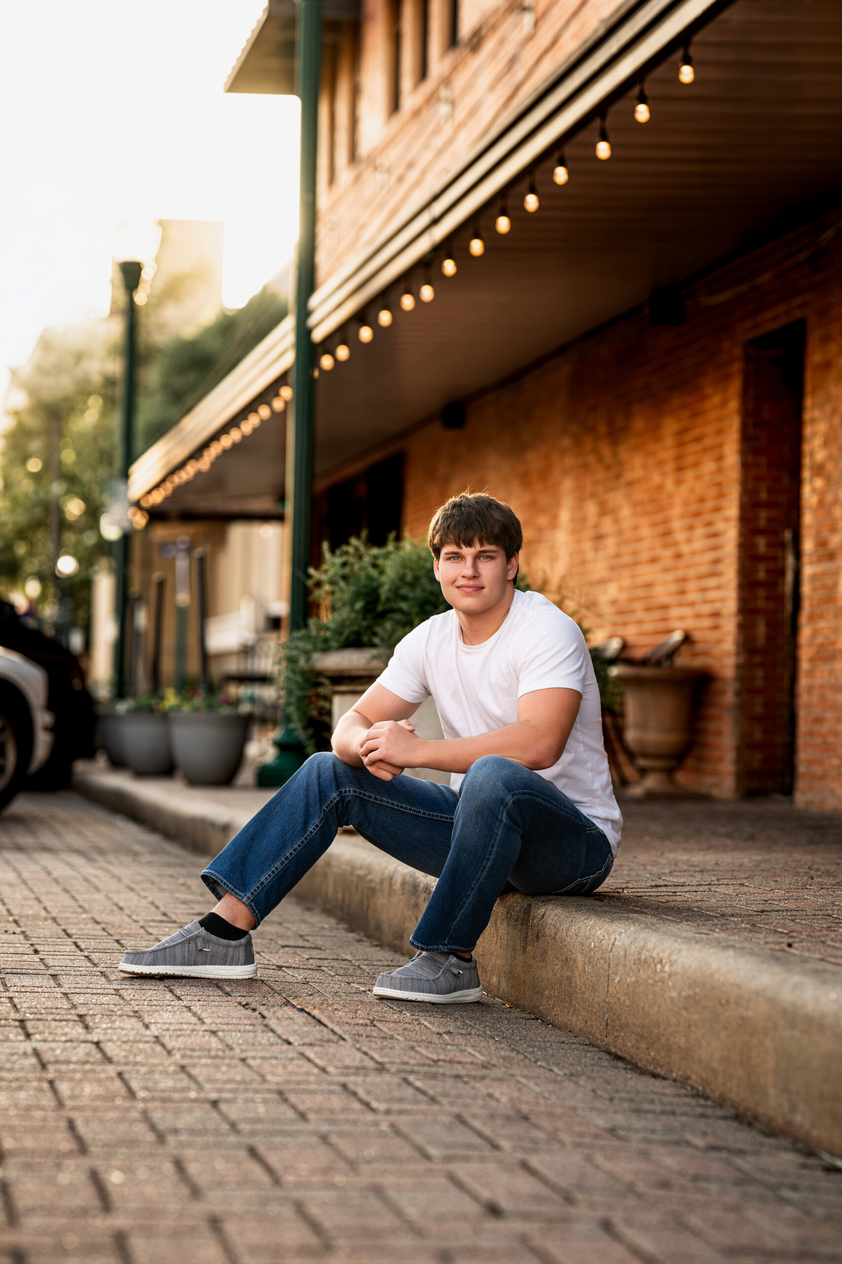 Senior Photographer Crosby High School 2 A senior high school student sitting on a curb near Crosby, Texas.