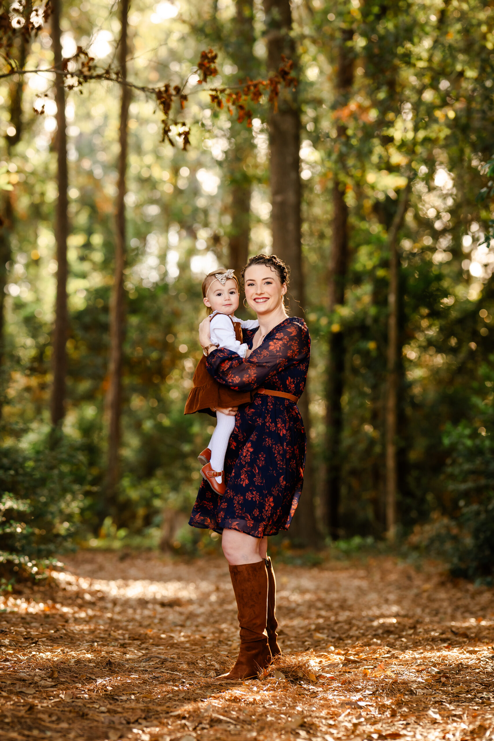 A picture of a mom and child standing in a forest in The Woodlands, Texas.