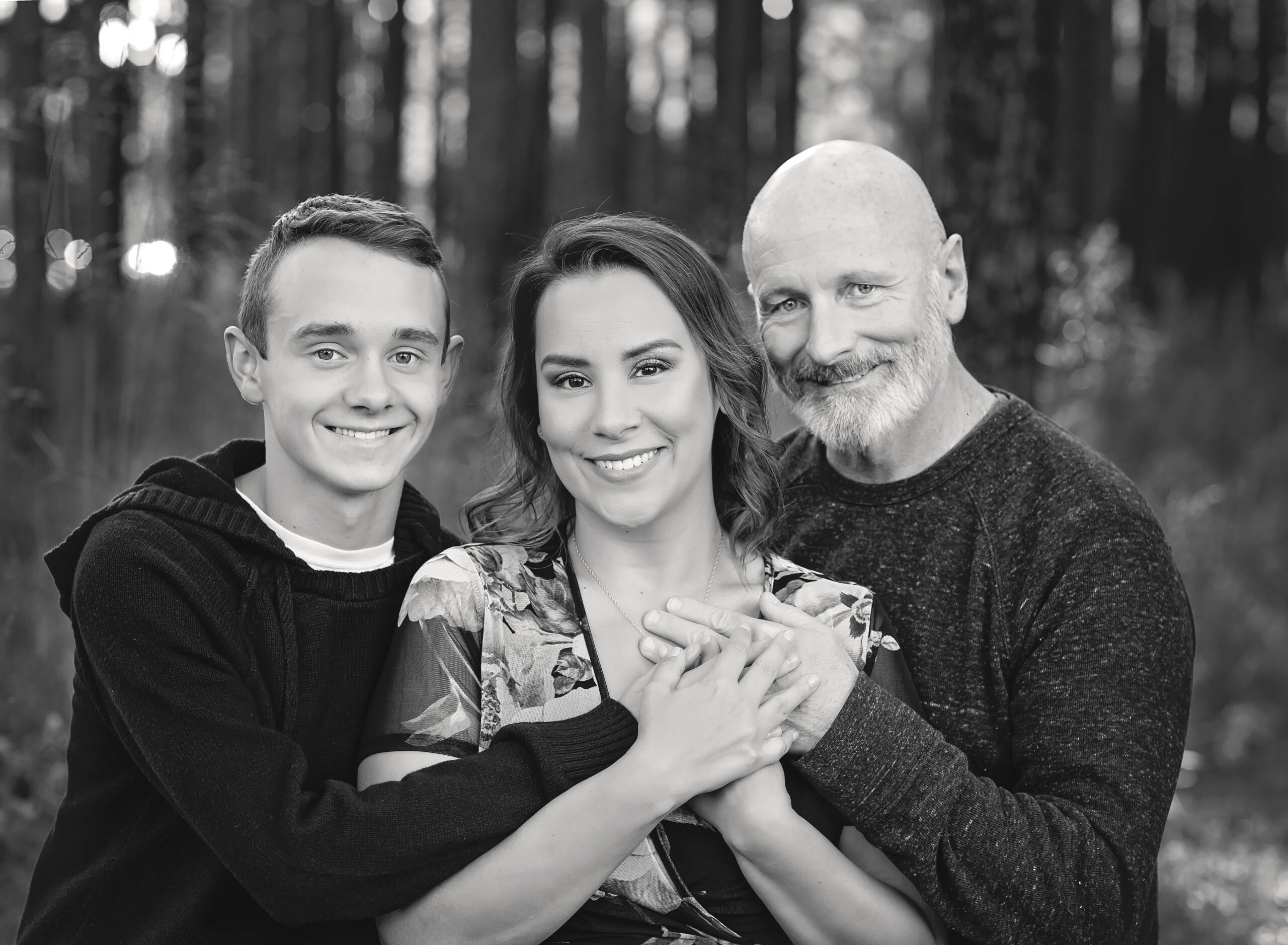 A picture of Bri Sullivan and her family standing in a forest setting at W G Jones State Forest.