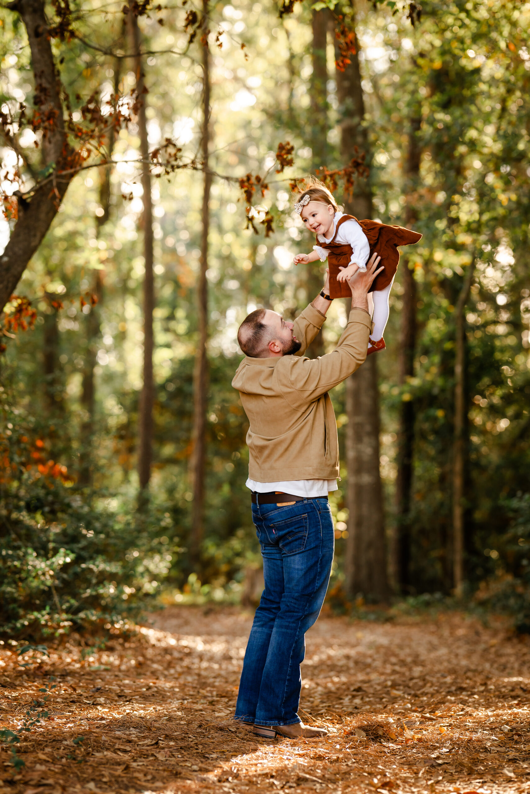 A picture of a dad and child standing in a forest in The Woodlands, Texas.