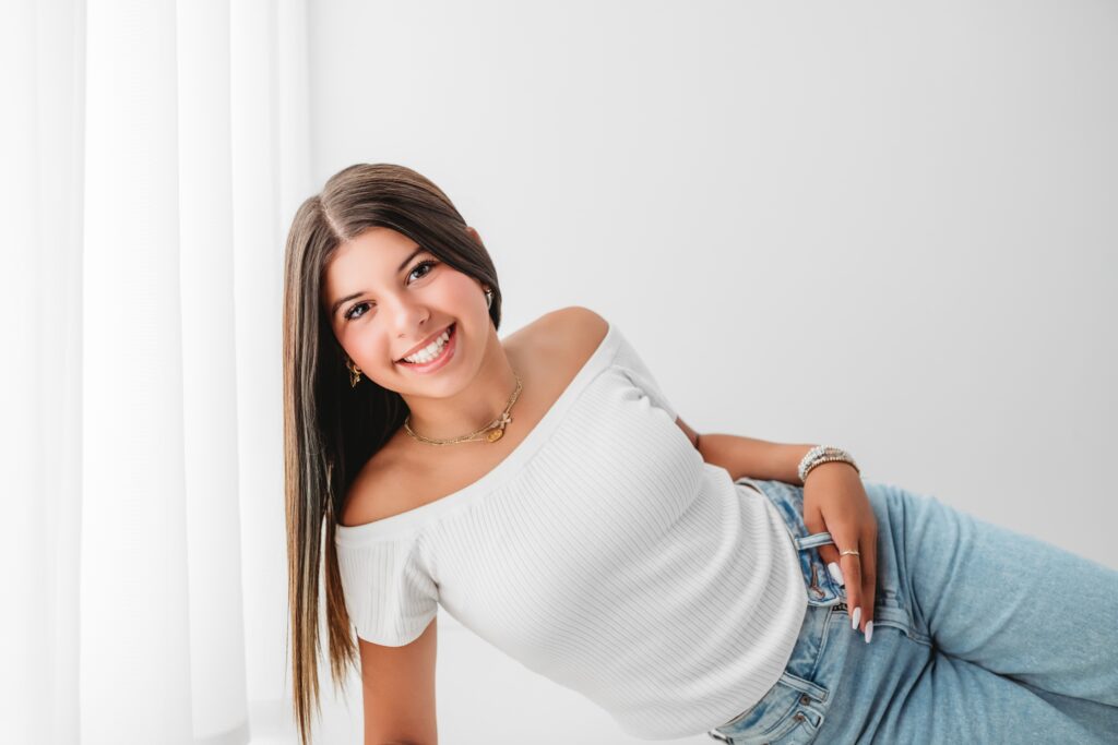 A picture of a high school senior posing for her senior portraits in The Woodlands, Texas.