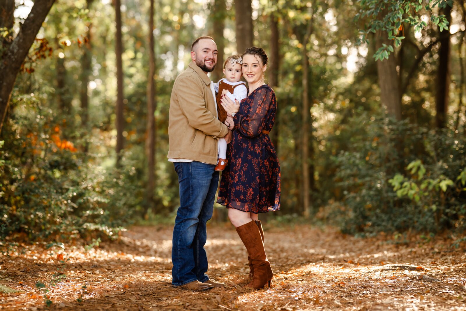 Picture of a family of three during an outdoor family photo session in Magnolia, Texas.