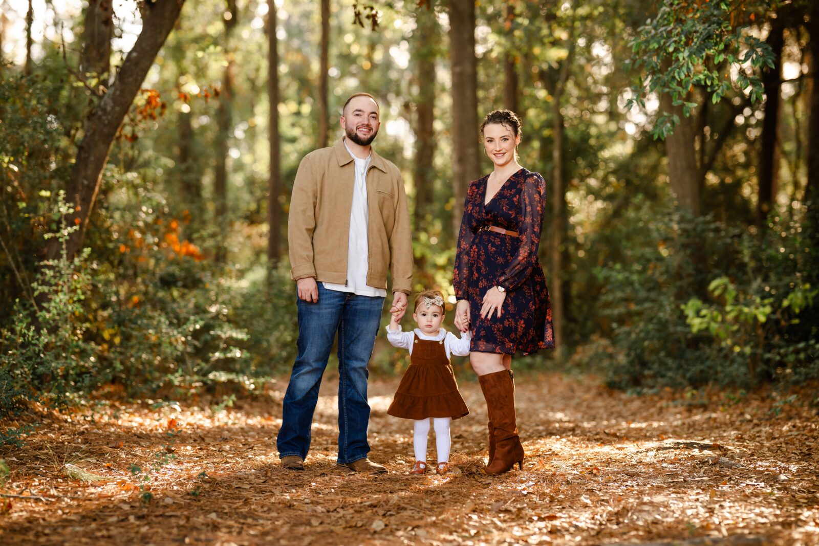 Picture of a family during an outdoor family photo session in Magnolia, Texas.
