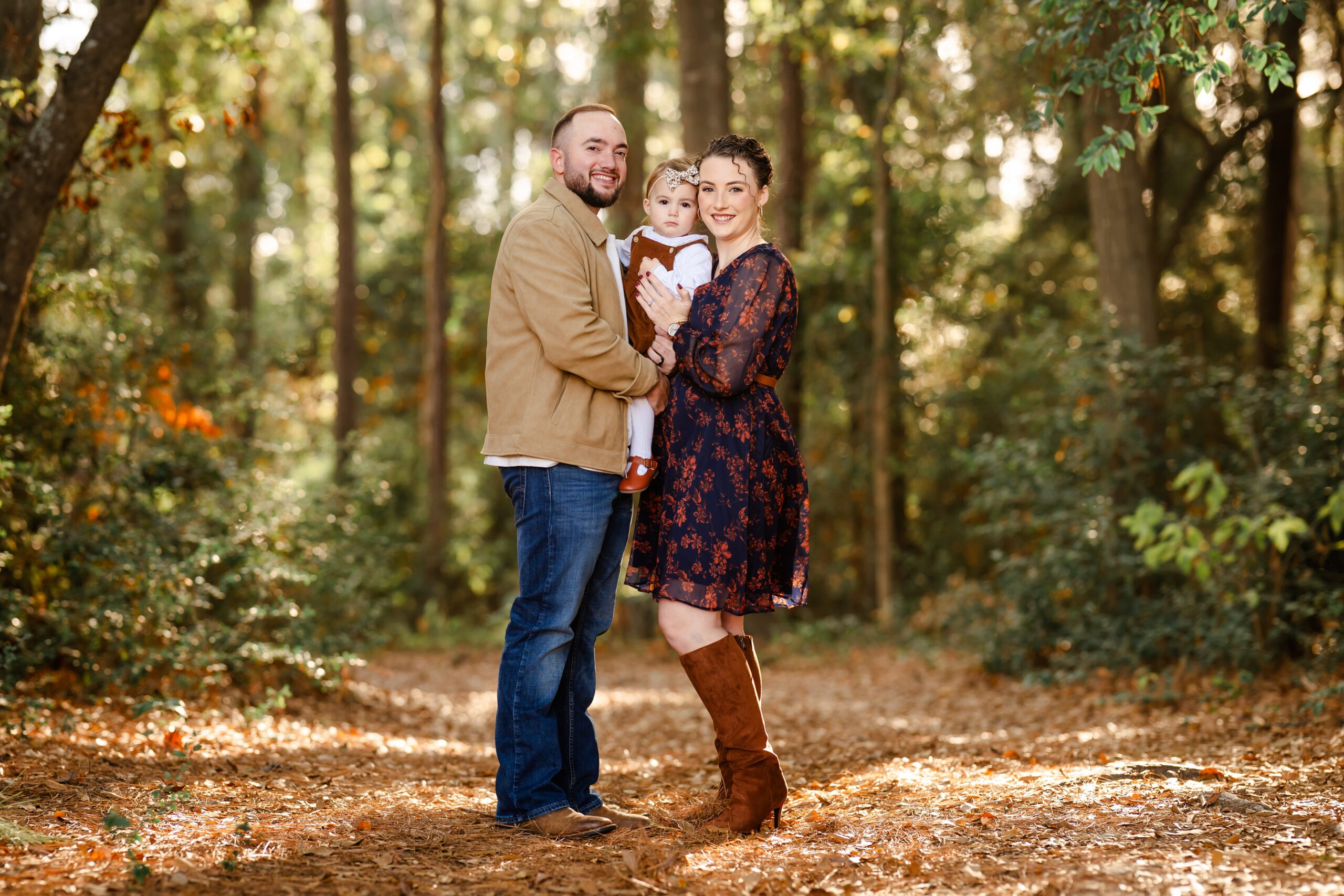 Picture of a family of 3 during an outdoor photo session in Willis, Texas.