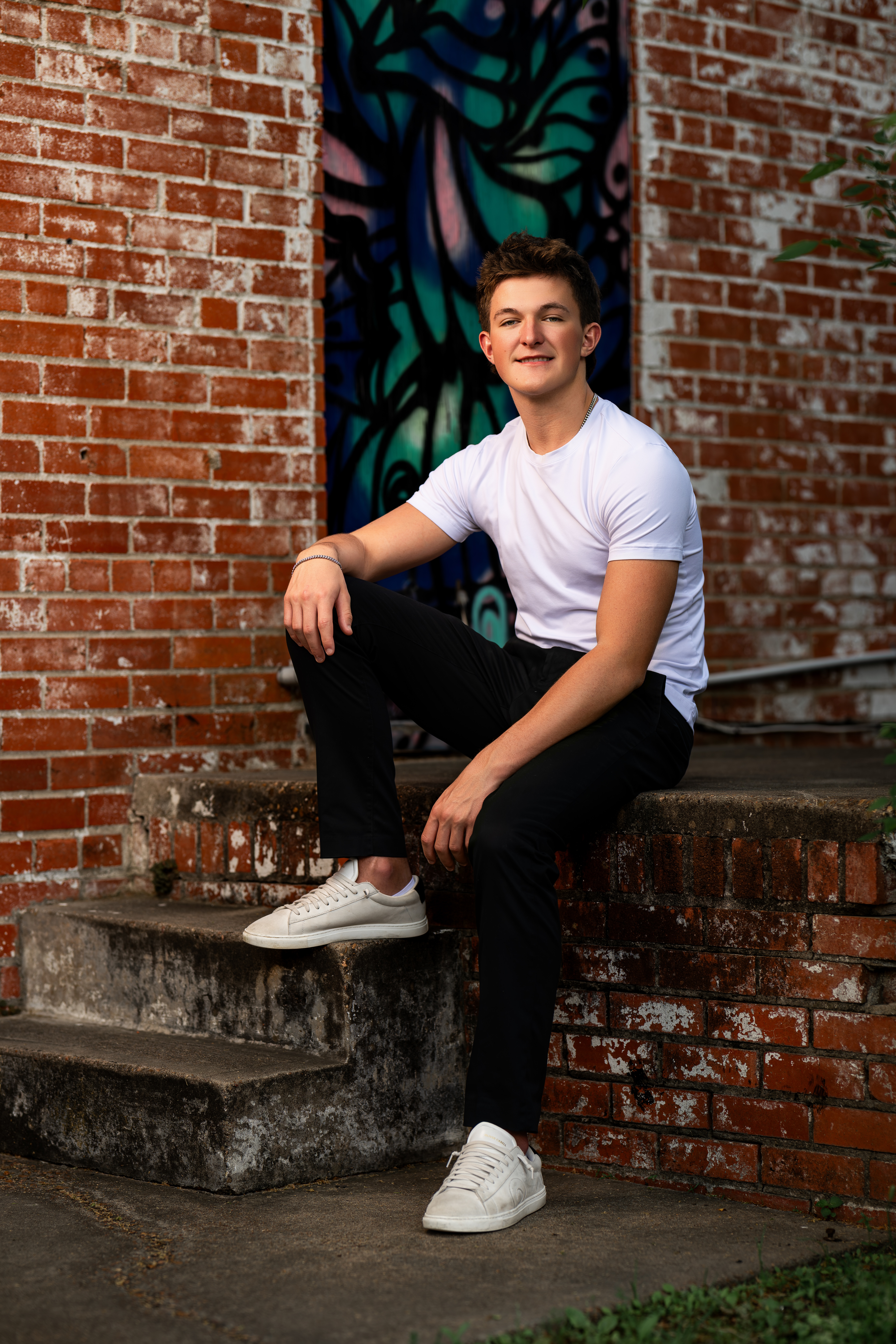 Picture of a senior high boy posing for his senior portraits near Conroe, Texas.