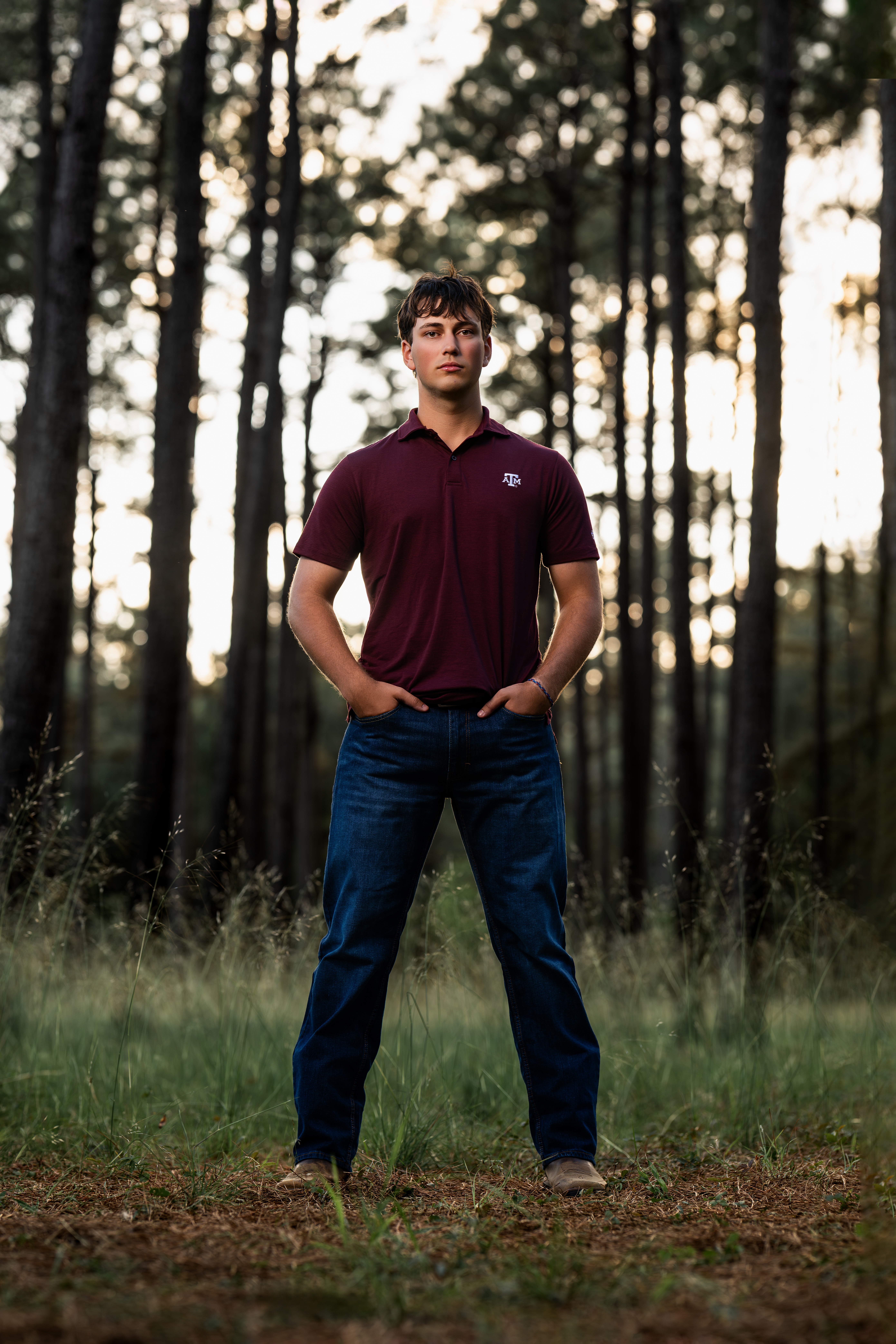 A picture of a senior high school student standing in a wooded area near Cypress, Texas.